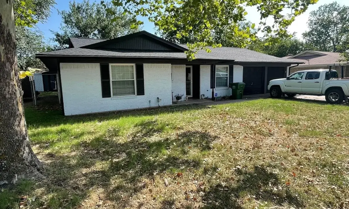 Professional roofing crew working on a residential roof in Lawrence